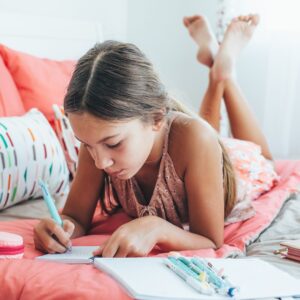 child writing in a journal