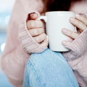 woman having a hot drink, utilizing self-care practices